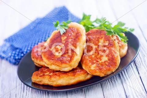 Cutlets on black plate on a table Stock Photos