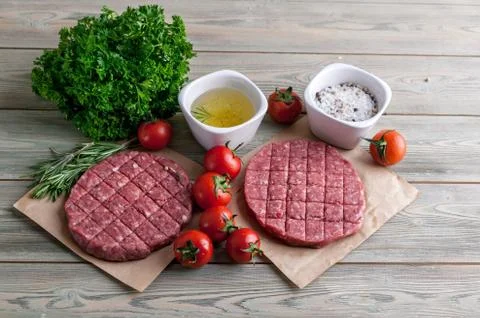 Cutlets for burgers from fresh minced meat with spices end herbs on a wooden Stock Photos