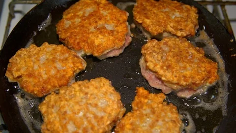 Cutlets fried in a pan Stock Footage 72565816