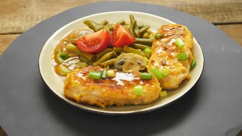 Cutlets with green beans and mushrooms in tomato sauce garnished  Stock Footage 221292995