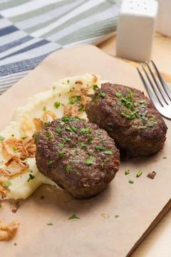 Cutlets with mashed potatoes and fried onions. Close up Stock Photos