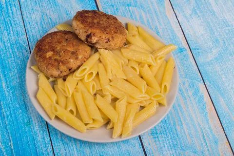 Cutlets with pasta on a plate Stock Photos