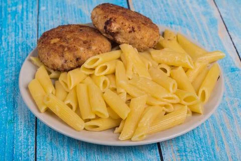 Cutlets with pasta on a plate Stock Photos