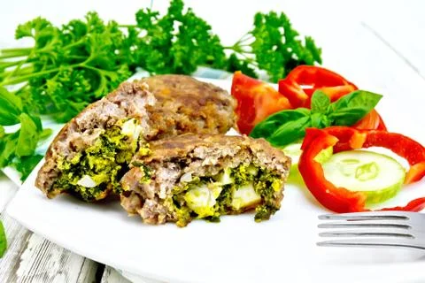 Cutlets stuffed in plate on board Stock Photos