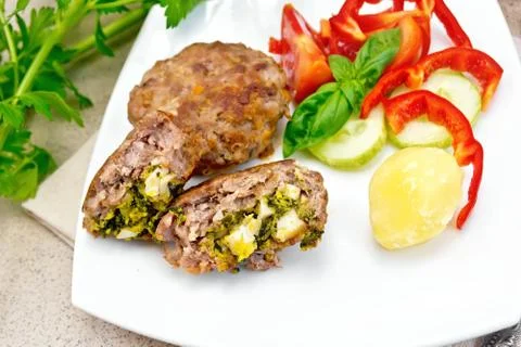 Cutlets stuffed in plate on granite table Stock Photos