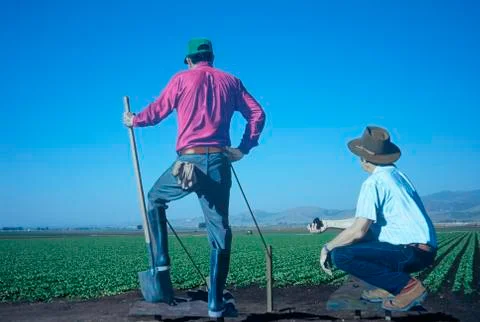 Cutouts of two farmers observing fields, CA Stock Photos