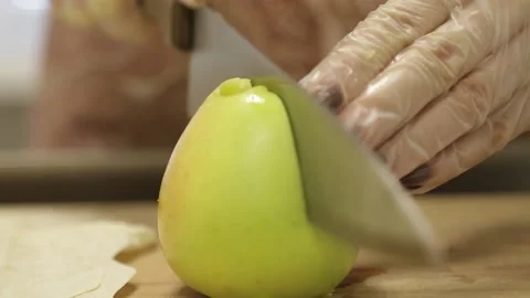Cuts an apple, pitted, with a knife Stock Footage 146574141