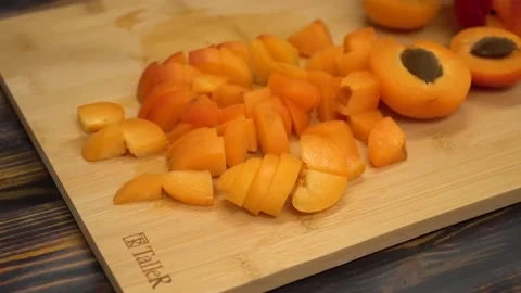 Cuts the apricot into small pieces Stock Footage 155298576