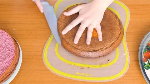 Cuts cake biscuit into two halves Stock-Footage 108555378