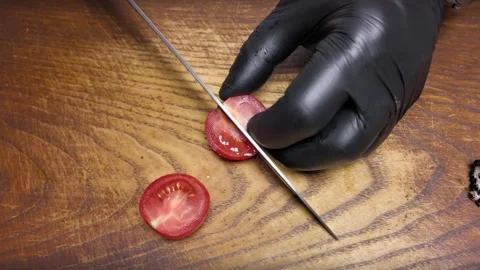 Cuts cherry tomatoes on a wooden board Stock Footage 302762183