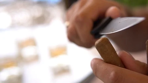 Cuts off the end of a cigar Stock Footage 101325543