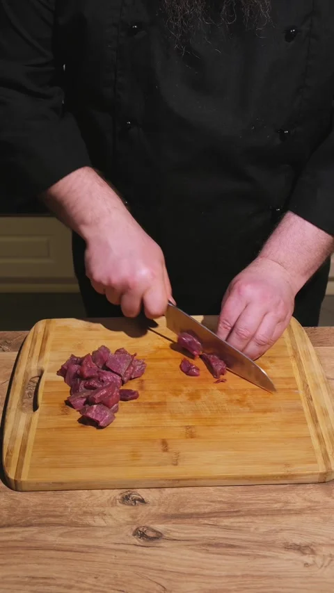 Cuts meat into small pieces Stock Footage 305305811