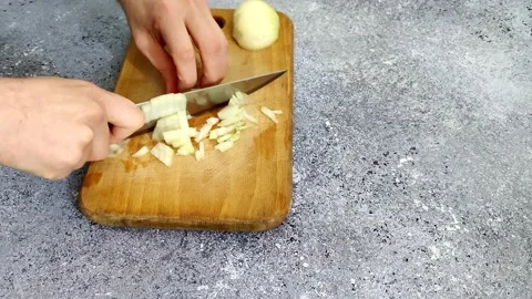 Cuts onions on a gray background Stock Footage 227722883
