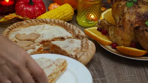 Cuts a pie for festive dinner at home. Thanksgiving  or Christmas dinner. Stock Footage 257598766