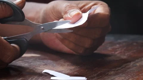 Cuts a sheet of white paper Stock Footage 335862610