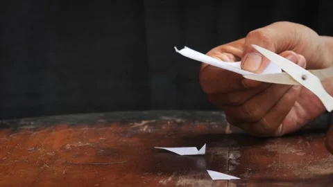 Cuts a sheet of white paper Stock Footage 335862625