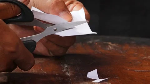Cuts a sheet of white paper Stock Footage 335862628