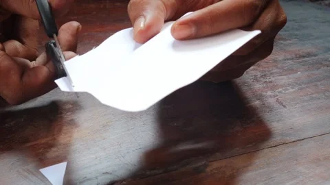 Cuts a sheet of white paper Stock Footage 335862629