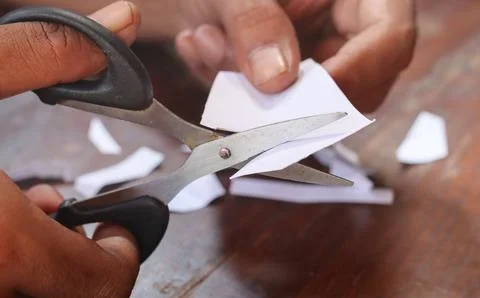 Cuts a sheet of white paper Stock Photos