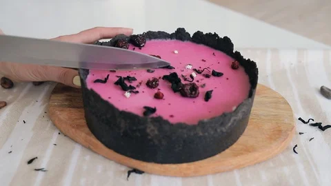 Cuts a slice from a berry cheesecake Stock Footage 129233798