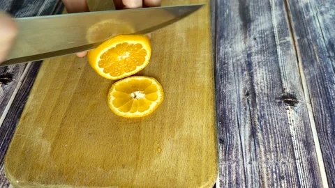 Cuts tangerines into segment Stock Footage 227722326