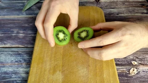 Cuts the tropical fruit kiwi Stock Footage 227722537