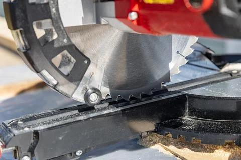 Cuts a wooden beam using a circular saw. Home furniture workshop. Work in his Stock Photos