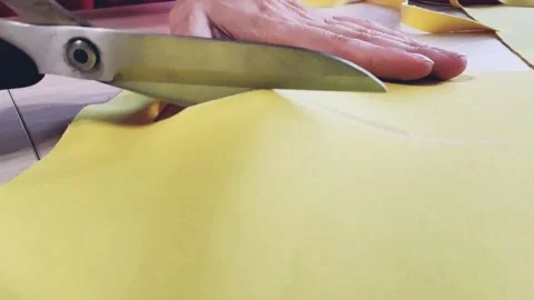 Cuts yellow cloth with scissors Stock-Footage 158753347