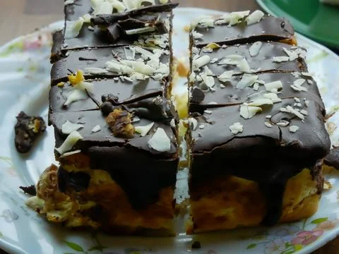 Cutted cake with chokolate glaze at top on a plate Stock Photos