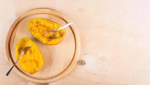 Cutted in halves mango on woden table Stock Photos