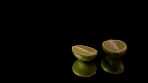 Cutted lemon lay on black mirror table Stock Footage 113005211