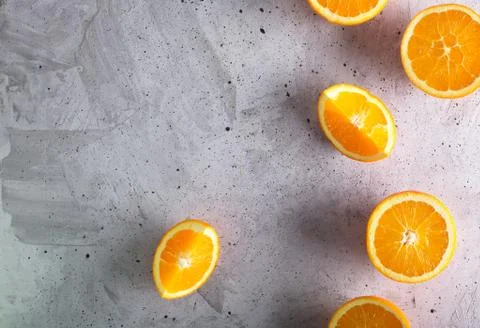 Cutted oranges on the gray background, top view 写真素材