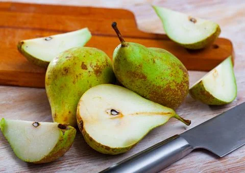 Cutted pears on wooden table Stock Photos