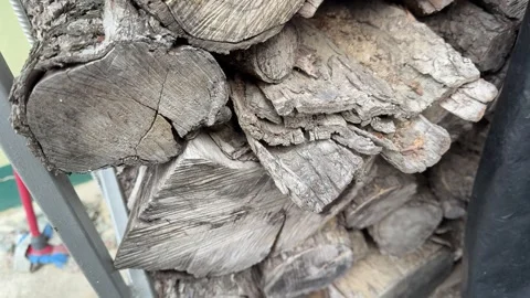 Cutted wood logs stack with numbers markers at sawmill on windy cloudy day Stock Footage 345848036