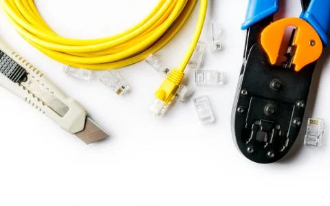 Cutter, crimper, yellow patch cord and connectors Stock Photos