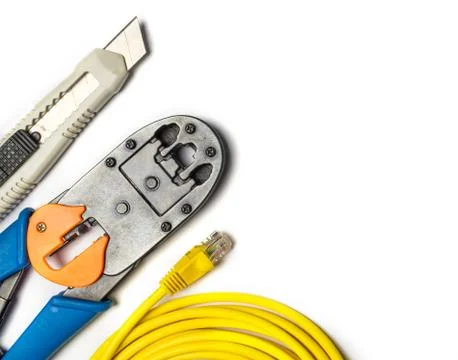 Cutter, crimper, yellow patch cord and connectors Stock Photos