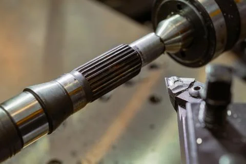Cutter lathe during the processing of the metal shaft. Stock Photos
