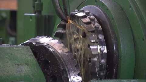 The cutter processes the part. For cooling and smooth cutting, oil is used. Stock Footage 79882371