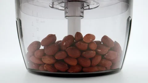 Cutter quickly crushes peanuts on a white background. Stock Footage 149158807