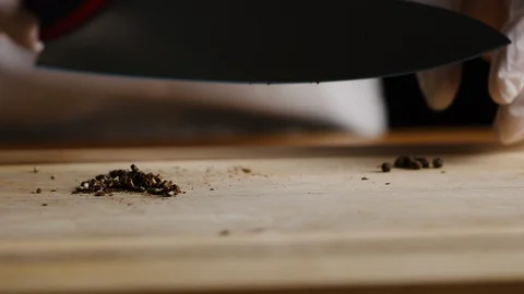 Cutting and crushing spices with chef knife macro shot 스톡 동영상 128490865