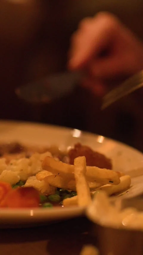 Cutting and Eating Steak Pie Dinner in Cozy Restaurant Setting Stock Footage 317538391