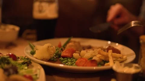 Cutting and Eating Steak Pie Dinner in Cozy Restaurant Stock Footage 318635018