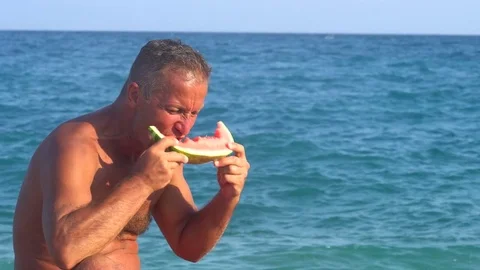 Cutting and eating Watermelon on the beach Stock Footage 80378836