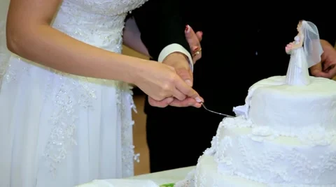 Cutting and folding plates on the wedding cake. Wedding couple. Stock Footage