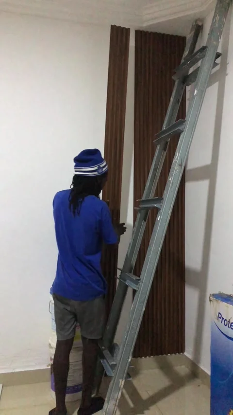 Cutting and Installing of Wall panel /wall paper in Accra, Ghana. March 26,2025 Stock Footage 318052960