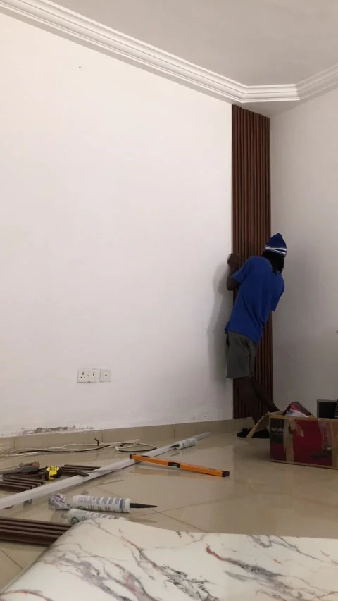 Cutting and Installing of Wall panel /wall paper in Accra, Ghana. March 26,2025 Stock Footage 318068697