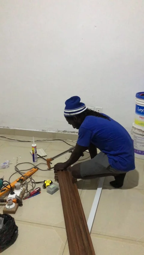 Cutting and Installing of Wall panel /wall paper in Accra, Ghana. March 26,2025 Stock Footage 318069312