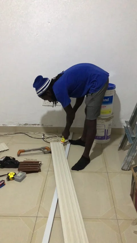 Cutting and Installing of Wall panel /wall paper in Accra, Ghana. March 26,2025 Stock Footage 318072320