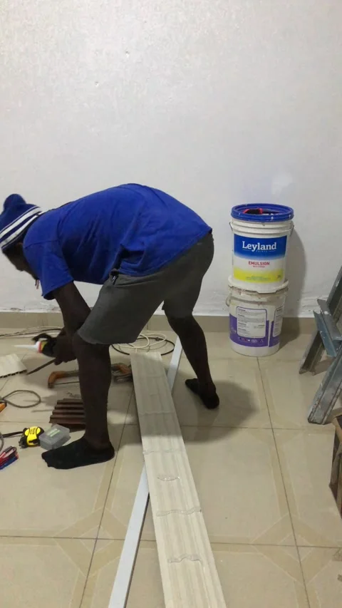 Cutting and Installing of Wall panel /wall paper in Accra, Ghana. March 26,2025 Stock Footage 318129736