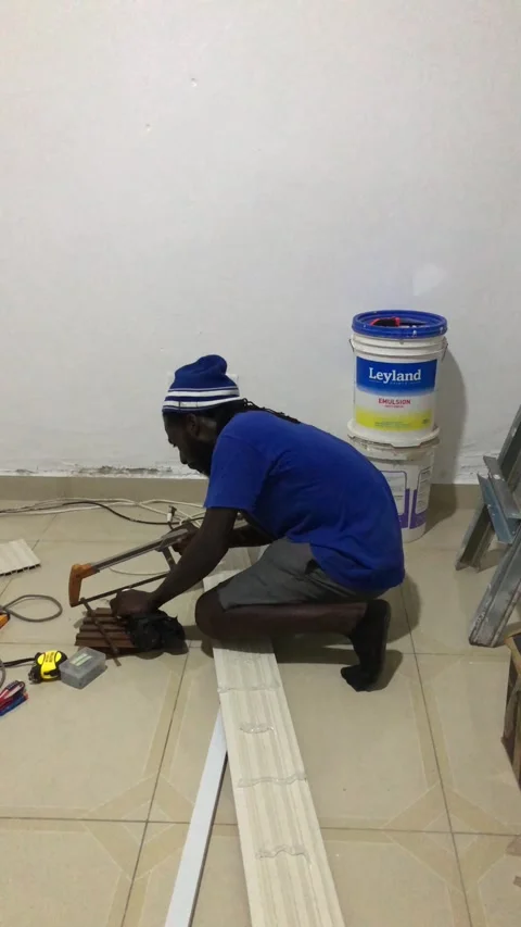 Cutting and Installing of Wall panel /wall paper in Accra, Ghana. March 26,2025 Stock Footage 318131147